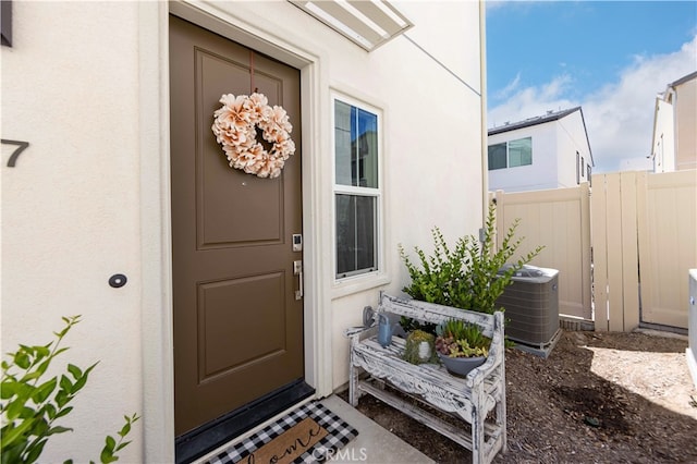 doorway to property featuring central AC unit