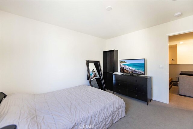 bedroom featuring light colored carpet