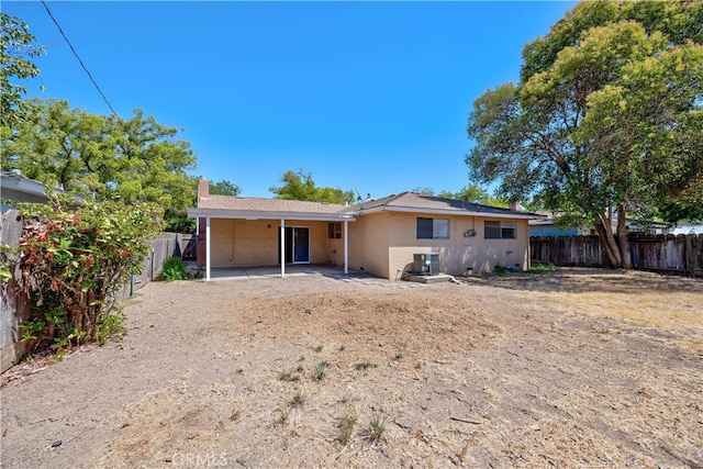 back of property featuring cooling unit and a patio area