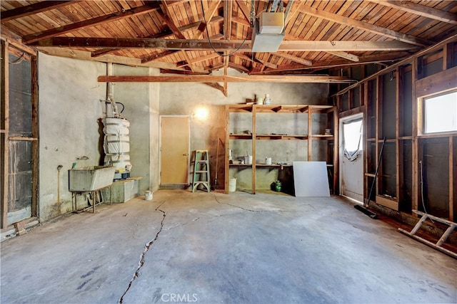 interior space with vaulted ceiling with beams, wood ceiling, and concrete flooring