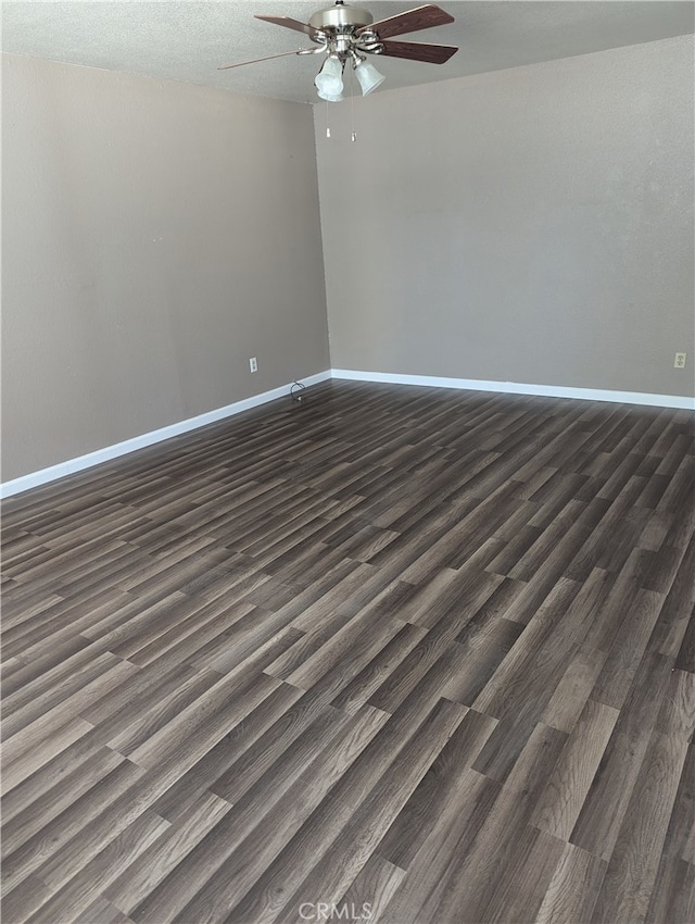 empty room with ceiling fan, a textured ceiling, and dark hardwood / wood-style flooring