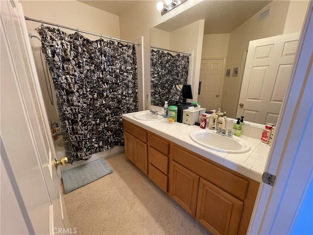 bathroom featuring shower / bath combo with shower curtain and vanity