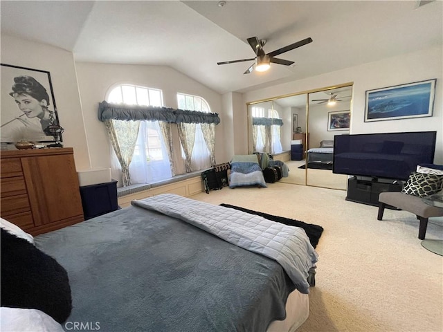 carpeted bedroom featuring ceiling fan, a closet, and vaulted ceiling