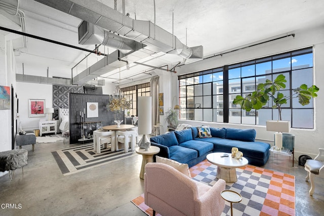 living room with concrete flooring and plenty of natural light