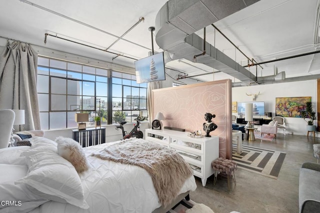 bedroom featuring concrete floors