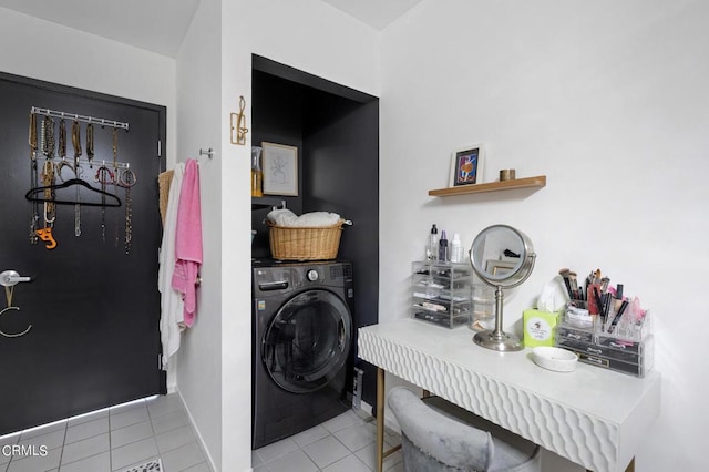 laundry room with light tile patterned floors and washer / dryer