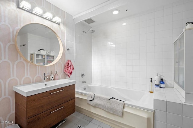 bathroom with vanity, tiled shower / bath combo, and tile patterned flooring