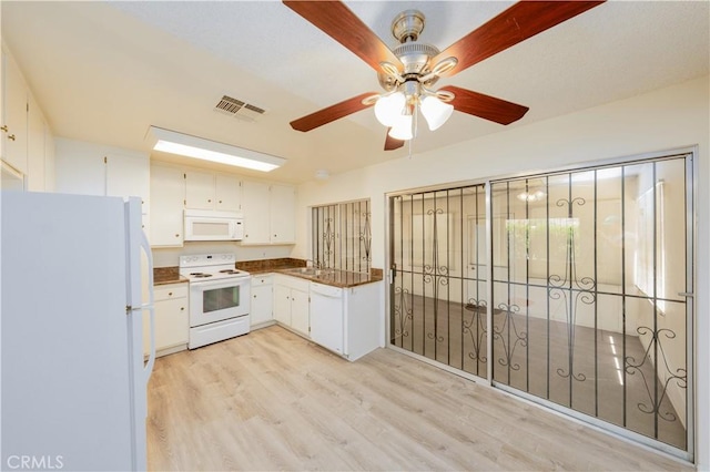 kitchen featuring white cabinets, white appliances, light hardwood / wood-style flooring, and sink