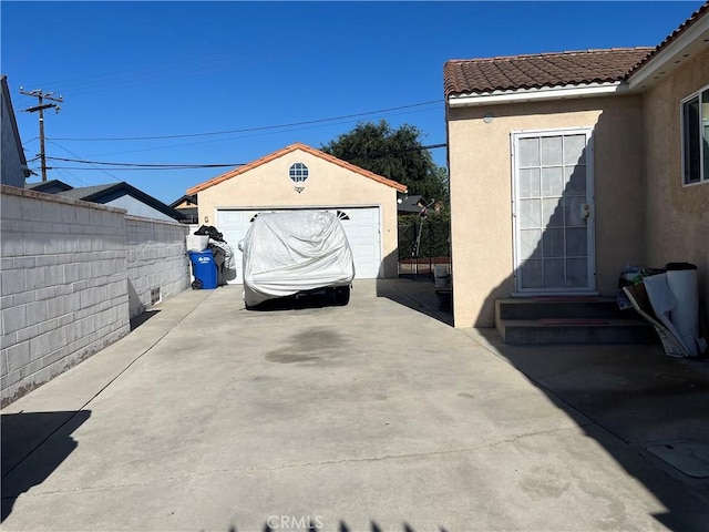 view of patio / terrace with an outbuilding and a garage