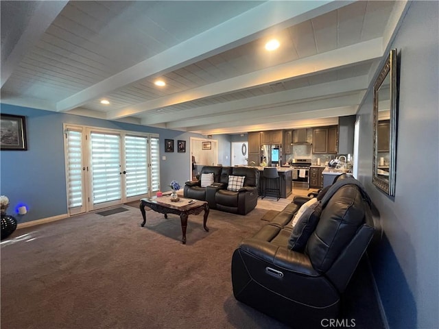 living room featuring beam ceiling and carpet floors