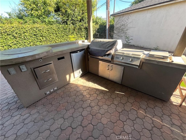 view of patio with a grill and exterior kitchen