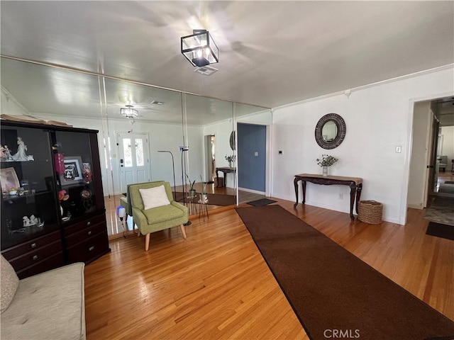 living room featuring hardwood / wood-style flooring and crown molding