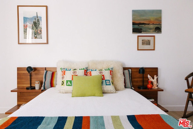 bedroom with hardwood / wood-style flooring