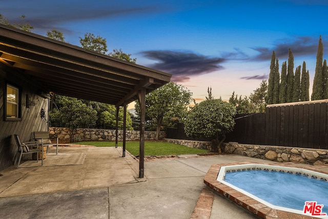 view of patio terrace at dusk