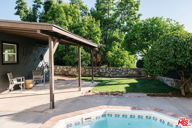 view of pool featuring a patio area and a lawn