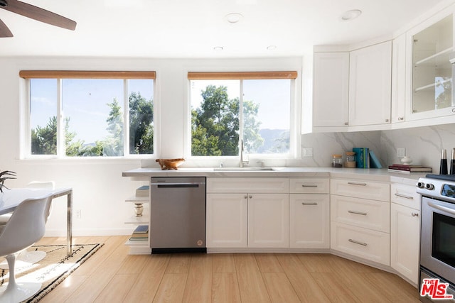 kitchen featuring white cabinets, light hardwood / wood-style floors, stainless steel appliances, and a wealth of natural light