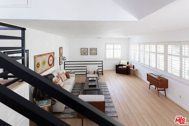 living room featuring light hardwood / wood-style floors and lofted ceiling