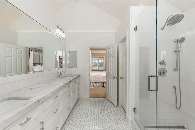 bathroom with a shower with door, vanity, and vaulted ceiling