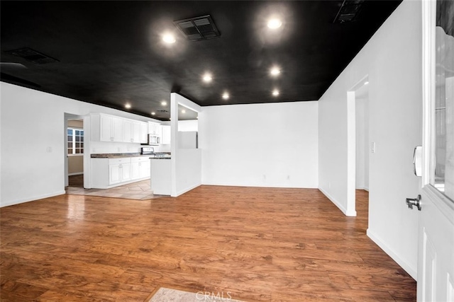 unfurnished living room with hardwood / wood-style flooring