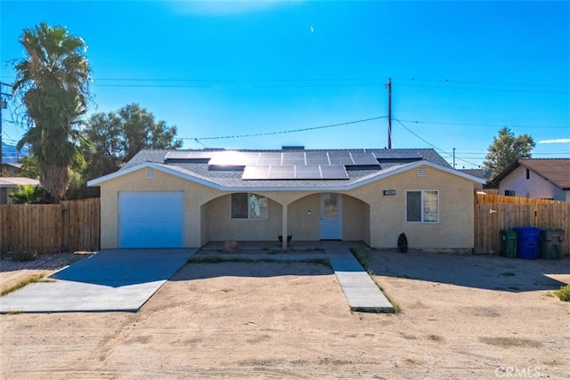 view of front of home featuring a garage and solar panels