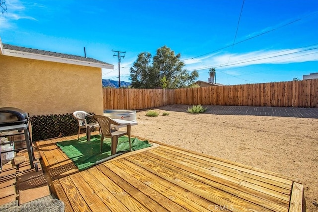 wooden terrace featuring area for grilling