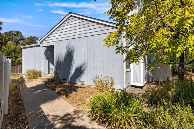 view of property exterior with an outbuilding