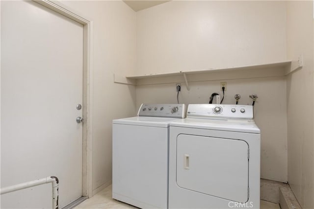 clothes washing area featuring washer and clothes dryer