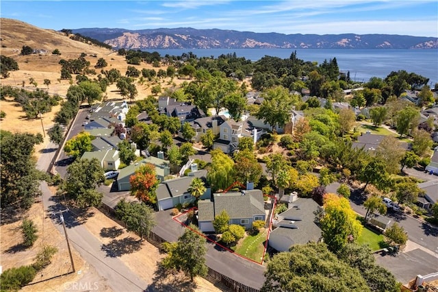 drone / aerial view with a water and mountain view