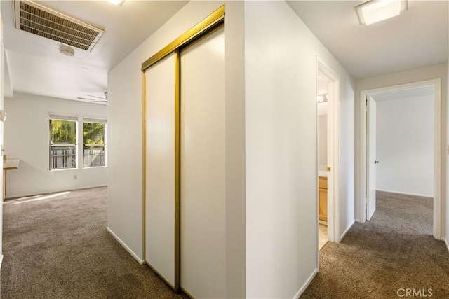 corridor with dark colored carpet