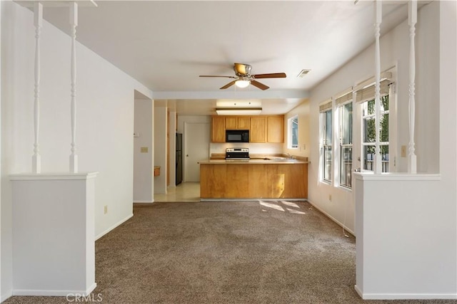 kitchen featuring kitchen peninsula, ceiling fan, carpet floors, and black appliances