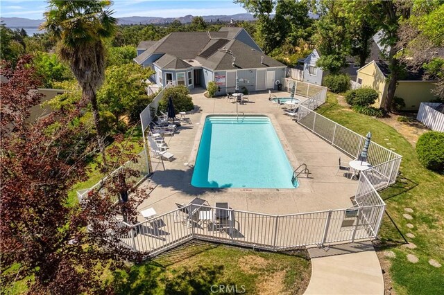 view of swimming pool featuring a patio area and a yard