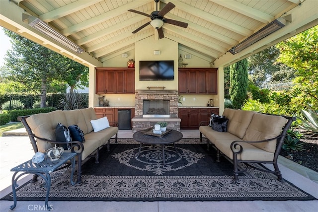 view of patio / terrace featuring an outdoor living space with a fireplace and ceiling fan