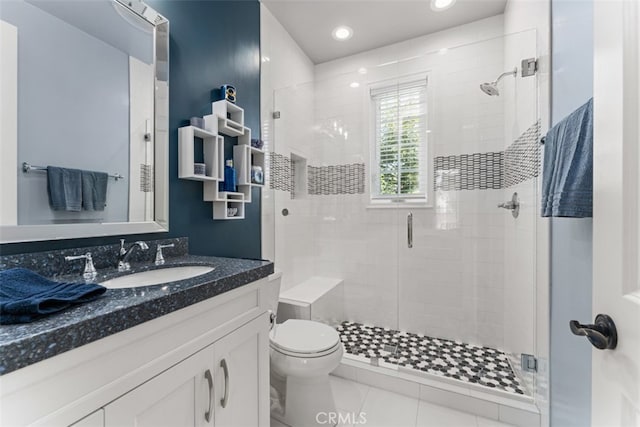 bathroom with vanity, tile patterned floors, toilet, and walk in shower