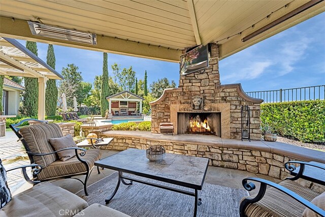 view of patio with an outdoor living space with a fireplace