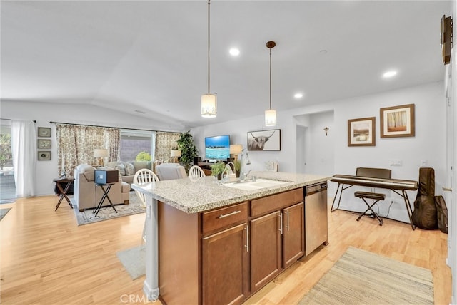 kitchen with light hardwood / wood-style flooring, a kitchen island with sink, and stainless steel dishwasher