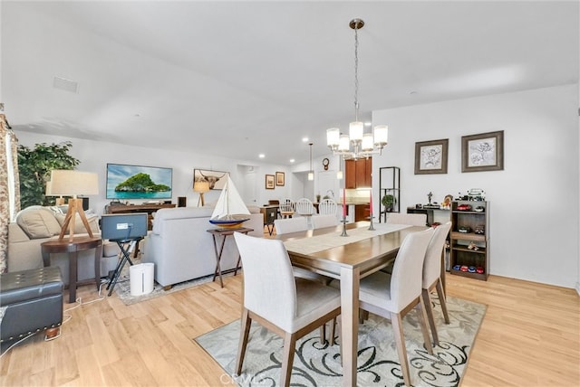 dining room featuring an inviting chandelier and light hardwood / wood-style floors