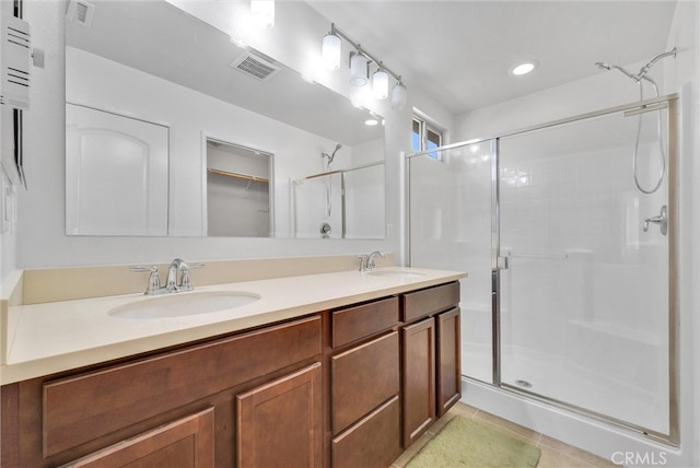 bathroom with vanity, tile patterned flooring, and an enclosed shower