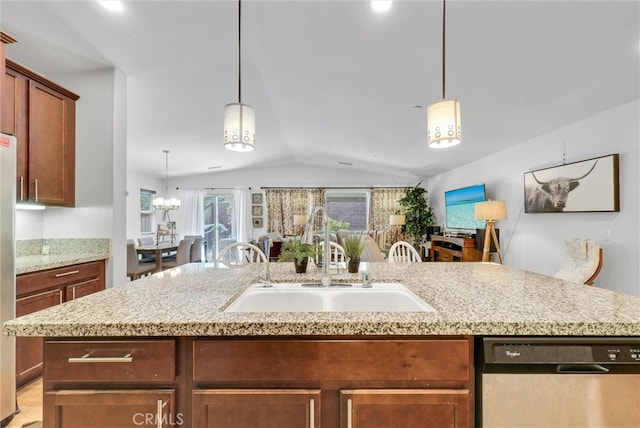 kitchen featuring pendant lighting, an island with sink, sink, stainless steel dishwasher, and vaulted ceiling