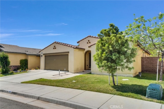 mediterranean / spanish home with a front yard and a garage