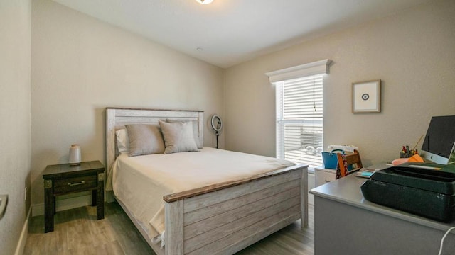 bedroom with hardwood / wood-style flooring and vaulted ceiling