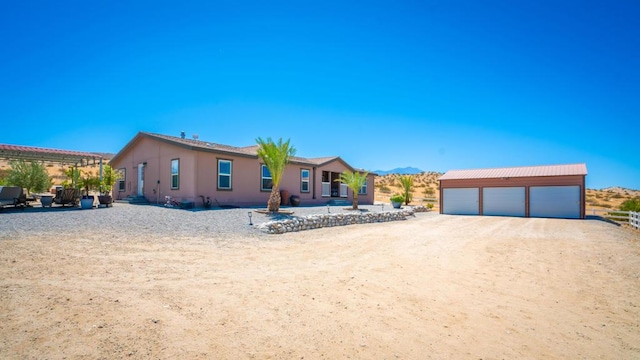 view of front of property featuring an outbuilding, a pergola, a mountain view, and a garage