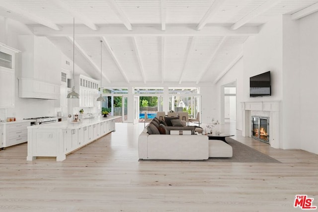 living room featuring beam ceiling, high vaulted ceiling, and light hardwood / wood-style flooring