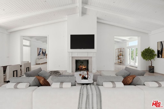 living room with vaulted ceiling with beams and a fireplace