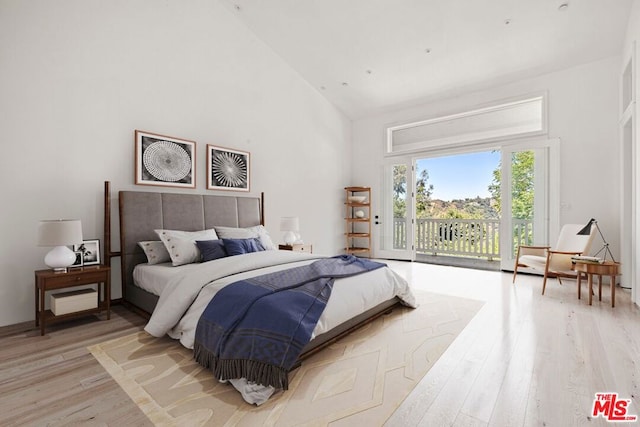 bedroom featuring access to outside, high vaulted ceiling, and light wood-type flooring