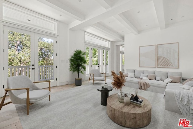 living room with beam ceiling and french doors