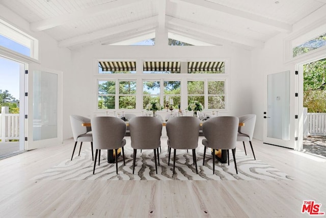 dining area featuring beam ceiling, high vaulted ceiling, and light hardwood / wood-style flooring