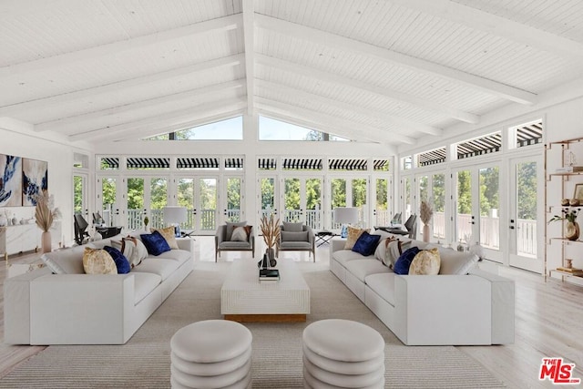 sunroom / solarium with lofted ceiling with beams and french doors