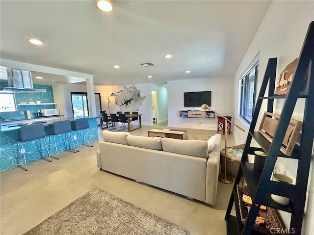 carpeted living room featuring plenty of natural light