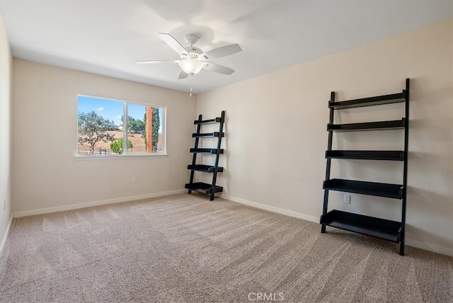 empty room with light colored carpet and ceiling fan