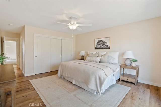 bedroom with light hardwood / wood-style floors and ceiling fan